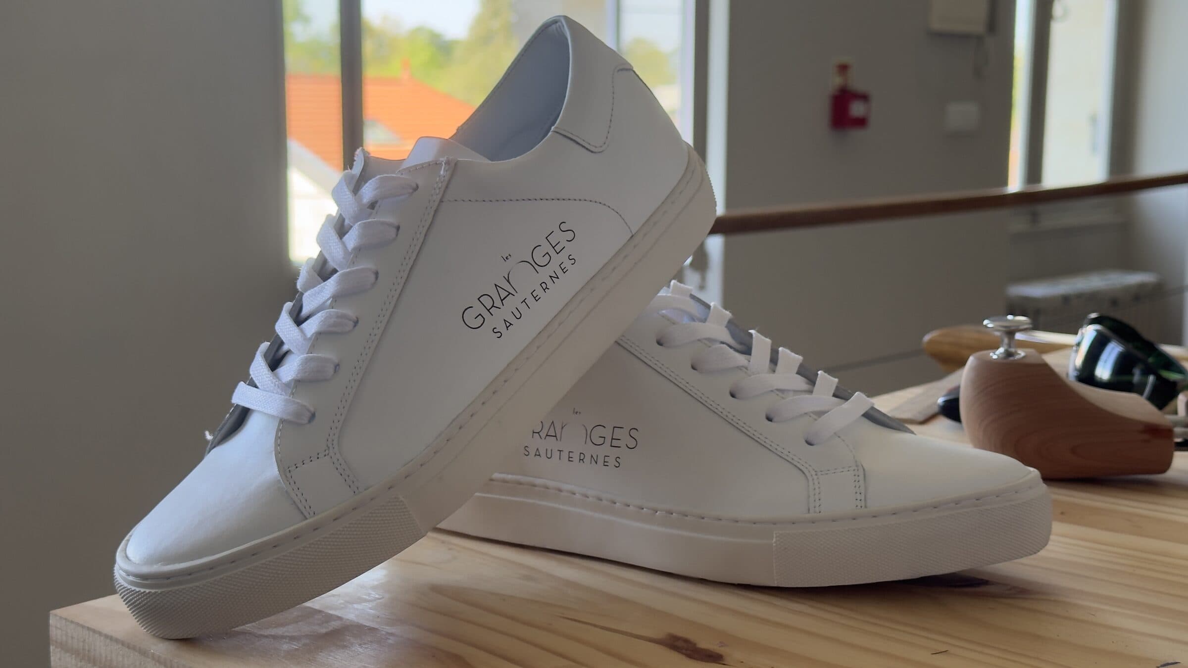 Laser-engraved client logo on a Karl & Max leather shoe in the workshop
